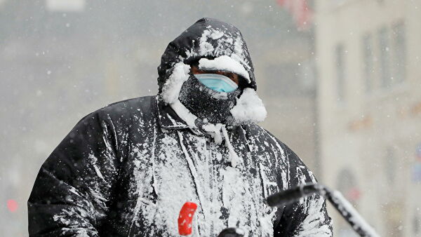 Работник чистит снег во время снегопада в Нью-Йорке