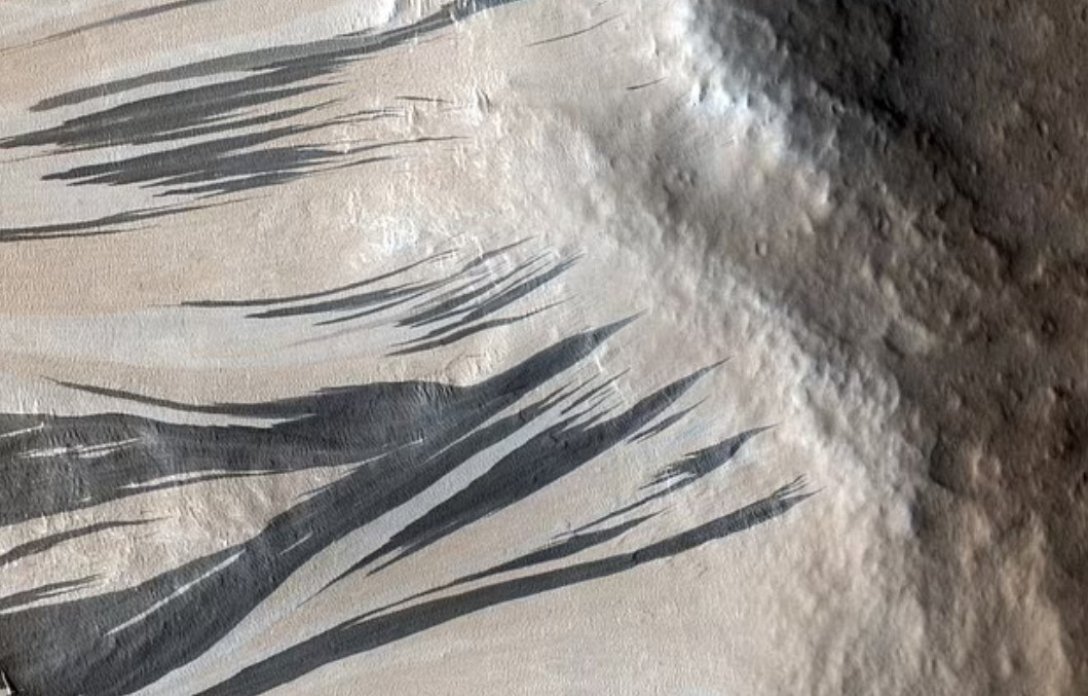 Это явление "грязного инея", вероятно, является причиной появления темных полос, которые тянутся вниз по склонам Марса