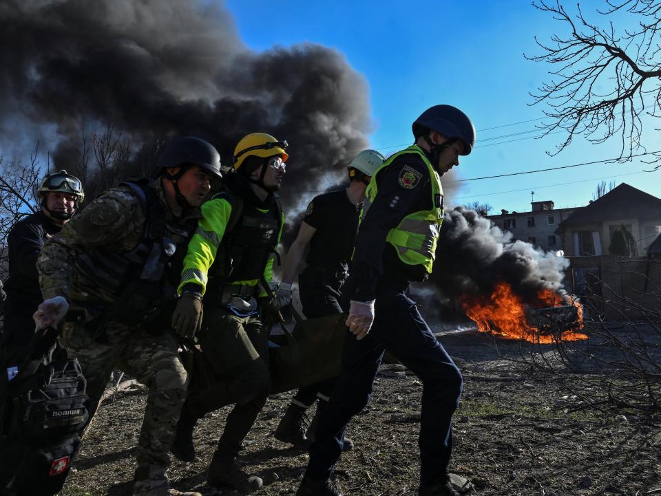 Emergency workers carry an injured woman at the site of a Russian missile strike in Zaporizhzhia on Friday (REUTERS)