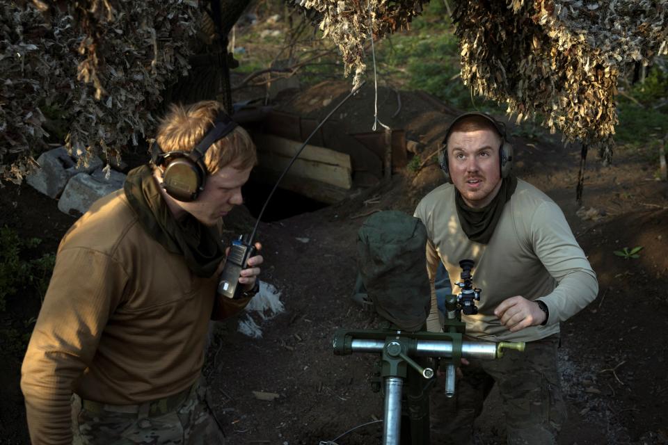 Members of a mortar unit, Roman and Woldemar, of Ukraine's 58th Motorized Brigade adjust the artillery at their position in the Donetsk region (REUTERS)