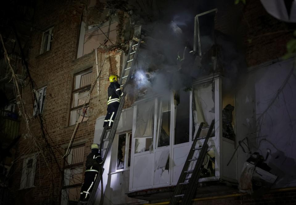 Firefighters work at a site of a residential building hit by a Russian missile strike, amid Russia’s attack on Ukraine, in Kharkiv, Ukraine 31 May 2024 (Reuters)