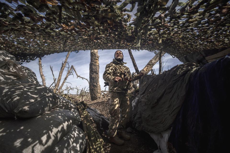 Infantry soldier Viktor of Ukraine's 58th Motorized Brigade scans the sky for enemy drones as he stands in a frontline trench in the Donetsk region (REUTERS)