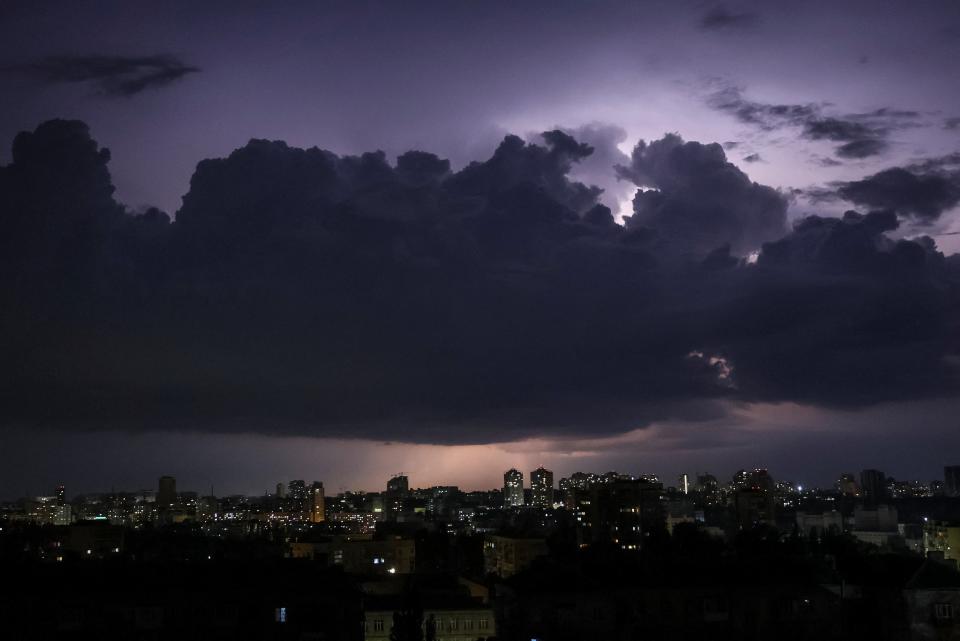 A flash from the lightning illuminates the sky over the city before a night storm in Kyiv (REUTERS)