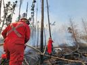 Firefighters from the La Ronge Regional Fire Department battle blazes in northern Saskatchewan in May 2023.